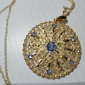Sterling silver gold pendant with six small and one large Tanzanite stones.